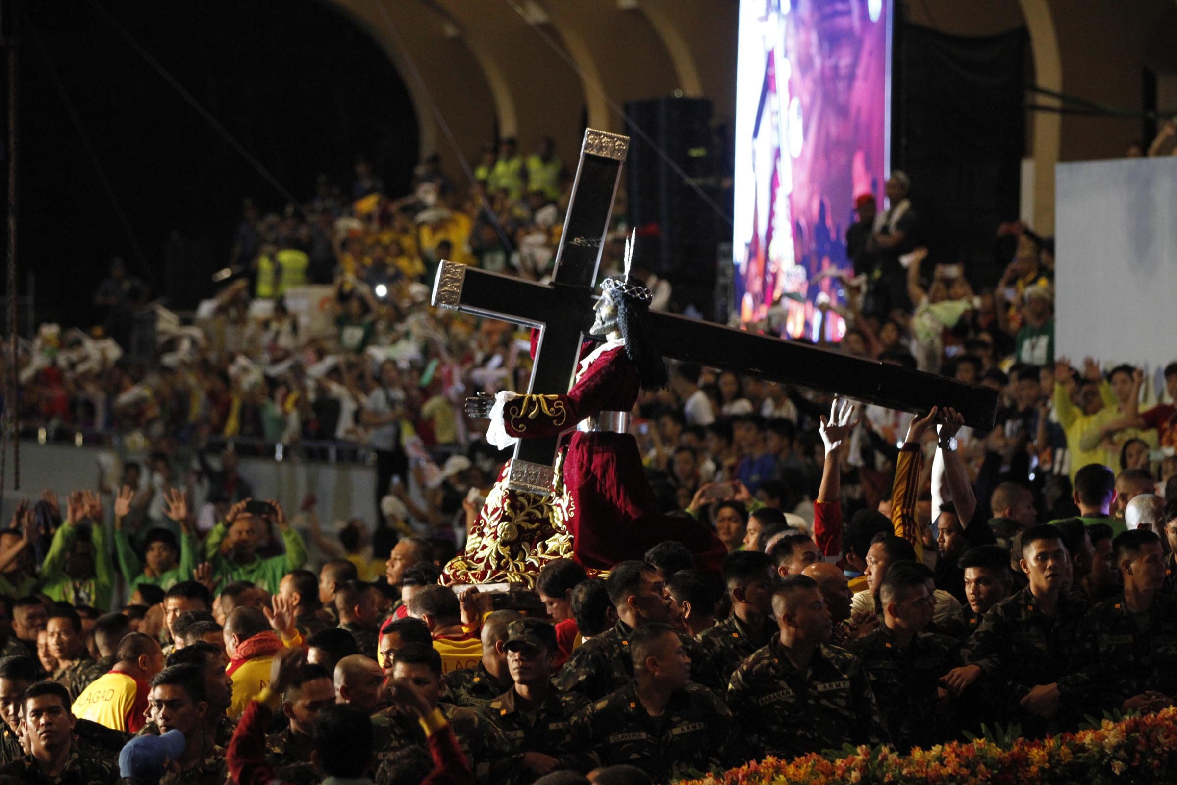 Devotees place the statue of the Black Nazarene into the Andas