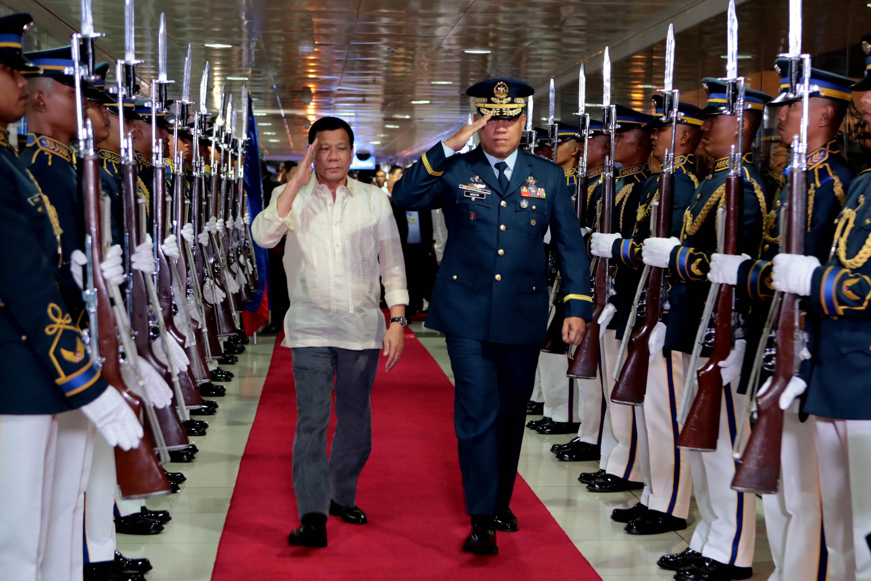 President Rodrigo Duterte walks past honor guards upon his arrival from Myanmar and Thailand