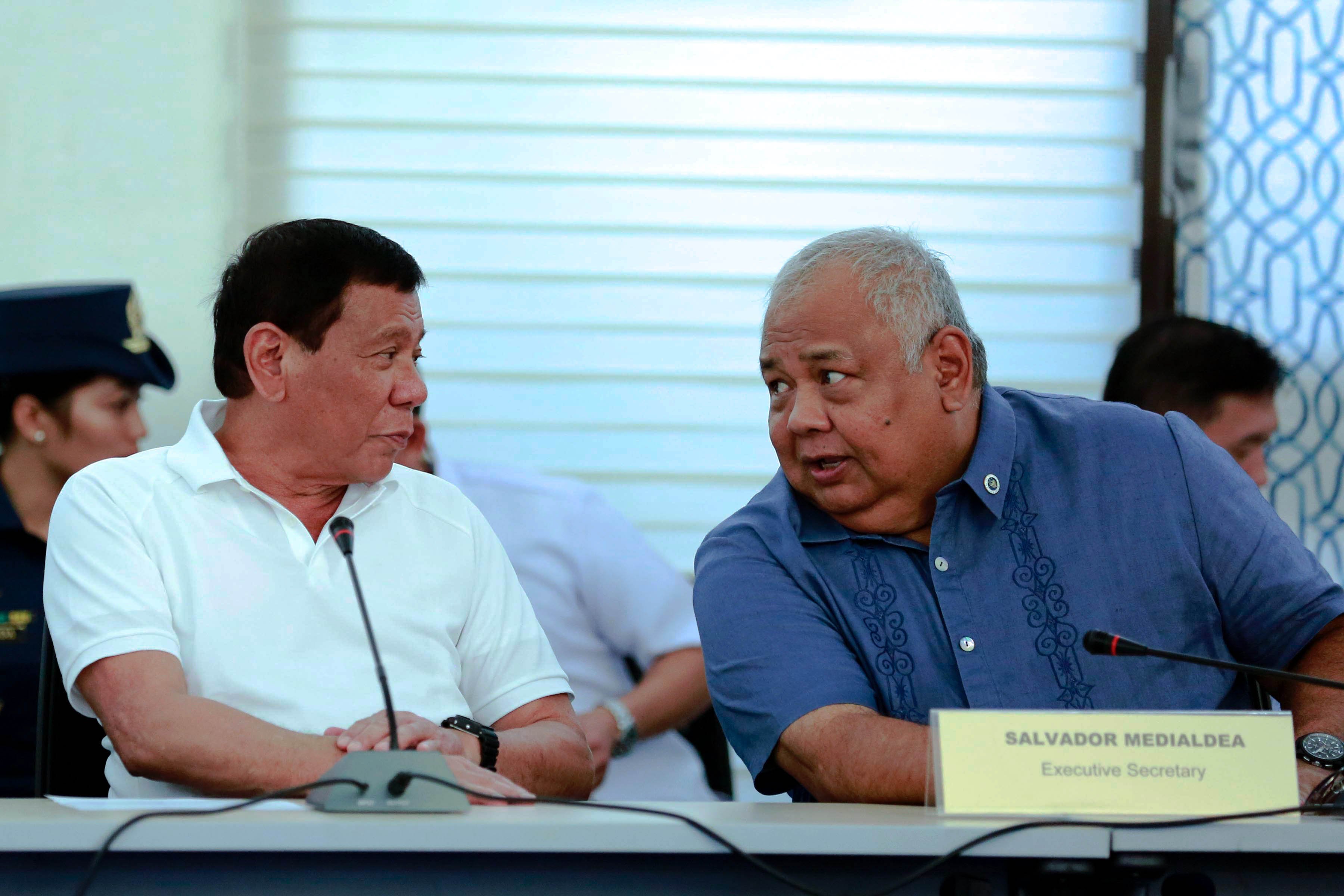 President Duterte speaks with Executive Secretary Salvador Medialdea