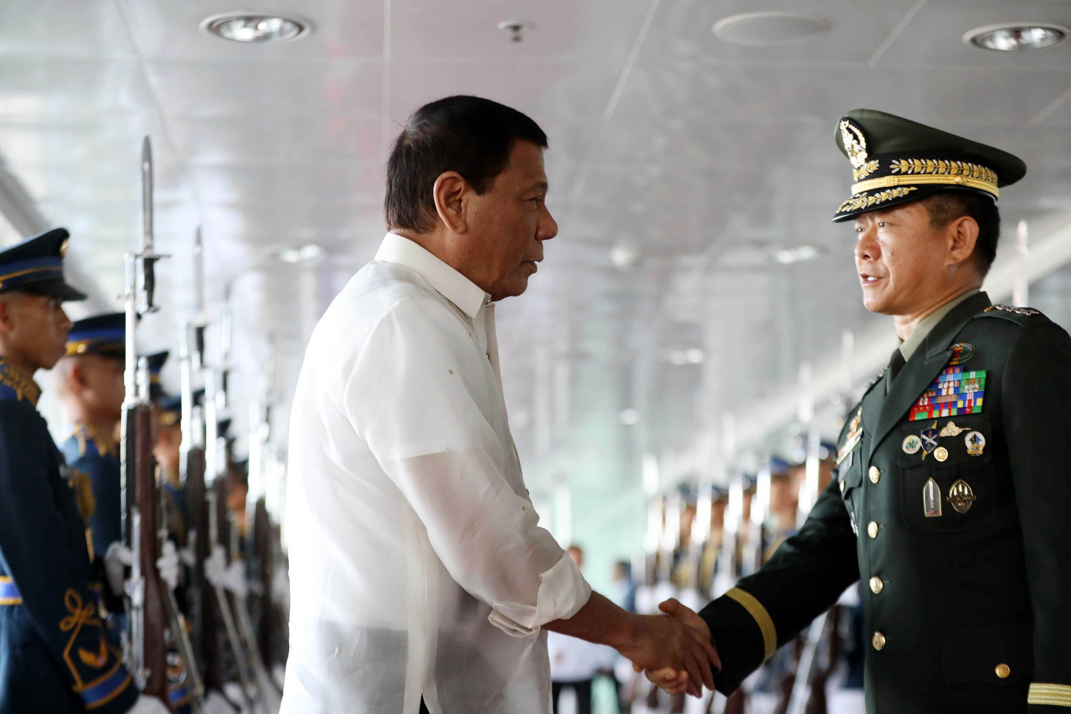 President Rodrigo Duterte shakes hands with Armed Forces of the Philippines Chief of Staff Lt. Gen. Eduardo Año