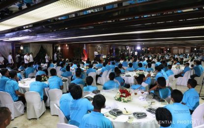 <p><strong>BACK TO THE FOLD OF THE LAW. </strong>President Rodrigo Roa Duterte talks to the surrenderees from the New People's Army during a dinner hosted by the President for the rebel returnees at the Malacañan Palace on March 6, 2018. <em>(Robinson Niñal Jr./Presidential Photo)</em></p>