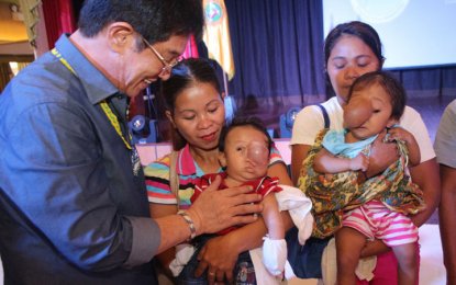 <p style="text-align: left;"><strong>MEDICAL AID ASSURED.</strong>DOH Mimaropa Regional Director Eduardo Janairo (left, holding baby) assures medical treatment and assistance to parents of two children suffering from 'meningocele' after they were flew in from Bataraza, southern Palawan, by the DOH air ambulance to Talisay, Batangas, where an ambulance immediately brought them to the regional office on March 16, 2018. They will be helped in their medical bills as indigent patients under MAIP.<em> (Photo courtesy of Glen S. Ramos, Community Affairs and Media Relations Officer, <span id="m_-5991933047377399470yui_3_16_0_ym19_1_1521480752313_30445">DOH Mimaropa)</span></em></p>
