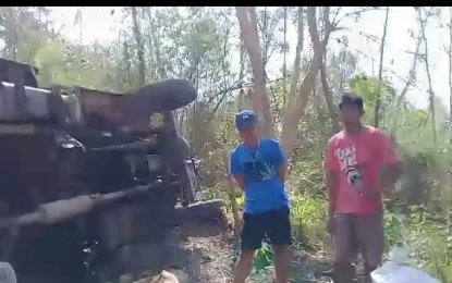 <p>Three persons, including a three-year old boy, died while 14 others were injured when a 6x6 truck turned turtle on rough road in the mountainous village of Pias in General Tinio, Nueva Ecija on Monday (March 26, 2018).<em>(Photo by Marilyn Galang)</em></p>