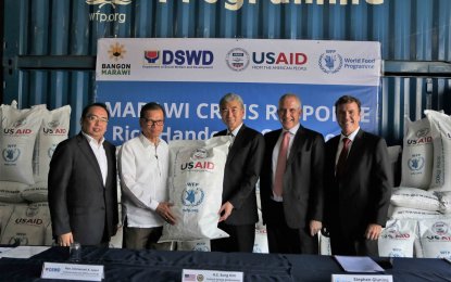 <p>Ambassador Sung Kim (center) leads the ceremonial handover of rice to Undersecretary Emmanuel Leyco, Officer-in-Charge of the Department of Social Welfare and Development (second from left) and Assistant Secretary Kristoffer James Purisima, Spokesperson of Task Force Bangon Marawi (leftmost) during the ceremonial handover held in Taguig City.  Also present are Stephen Gluning, Country Director of the World Food Programme (second from right) and Clay Epperson, Deputy Mission Director of USAID-Philippines. <em>(Photo courtesy of US Embassy Manila)</em></p>