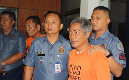 <p><strong>SWINDLERS NABBED. </strong>CIDG operatives in uniform present Henry Halagyan and Jose Matias (both in detainee orange shirts) who extorted money claiming to be relatives of the president and of being Malacanang officials.</p>