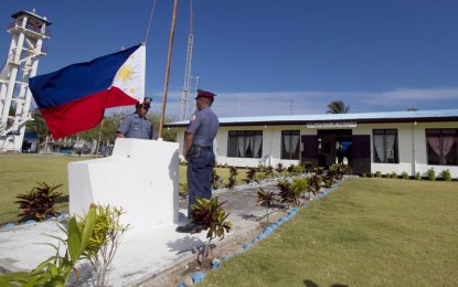 <p style="text-align: left;"><strong>LET THERE BE LIGHT</strong>. Two policemen prepare to raise the Philippine flag on Barangay Pag-asa Island in Kalayaan town, West Philippines Sea in this file photo. The National Power Corporation has pledged to give two units of power generator to supply the village for eight hours of electricity daily. <em>(Photo by CARF)</em></p>