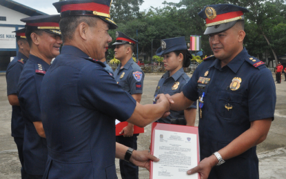 <p>Chief Supt. Edwin de Ocampo, PRO-9 deputy regional director for administration (DRDA) (left), on Monday leads the awarding of “Medalya ng Kagalingan” to 20 officers and personnel for exemplary performance in the campaign against lawless elements in Region 9. <em><strong>(Photo courtesy: PRO-9 PIO)</strong></em></p>
