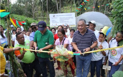 <p><strong>PROJECT TURNOVER.</strong> Cebu Governor Hilario Davide III (right) leads the ribbon-cutting ceremony during the turnover of the small water-impounding tank project in Barangay Alambijud, Argao, Cebu. (<em>Photo courtesy of the Cebu Provincial Public Information Office)</em></p>