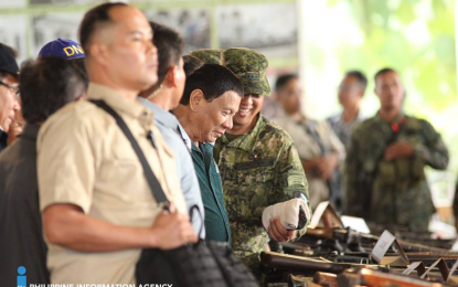 <p>Lt. Gen. Carlito Galvez Jr., Western Mindanao Command (Westmincom) chief (partly covered), presents to President Rodrigo Duterte the 652 firearms during the President’s visit on Monday in Jolo, Sulu. The firearms were surrendered by local government officials, including barangay officials and resients, to the Joint Task Force Sulu. <em><strong>(Photo courtesy: PIA-9)</strong></em></p>