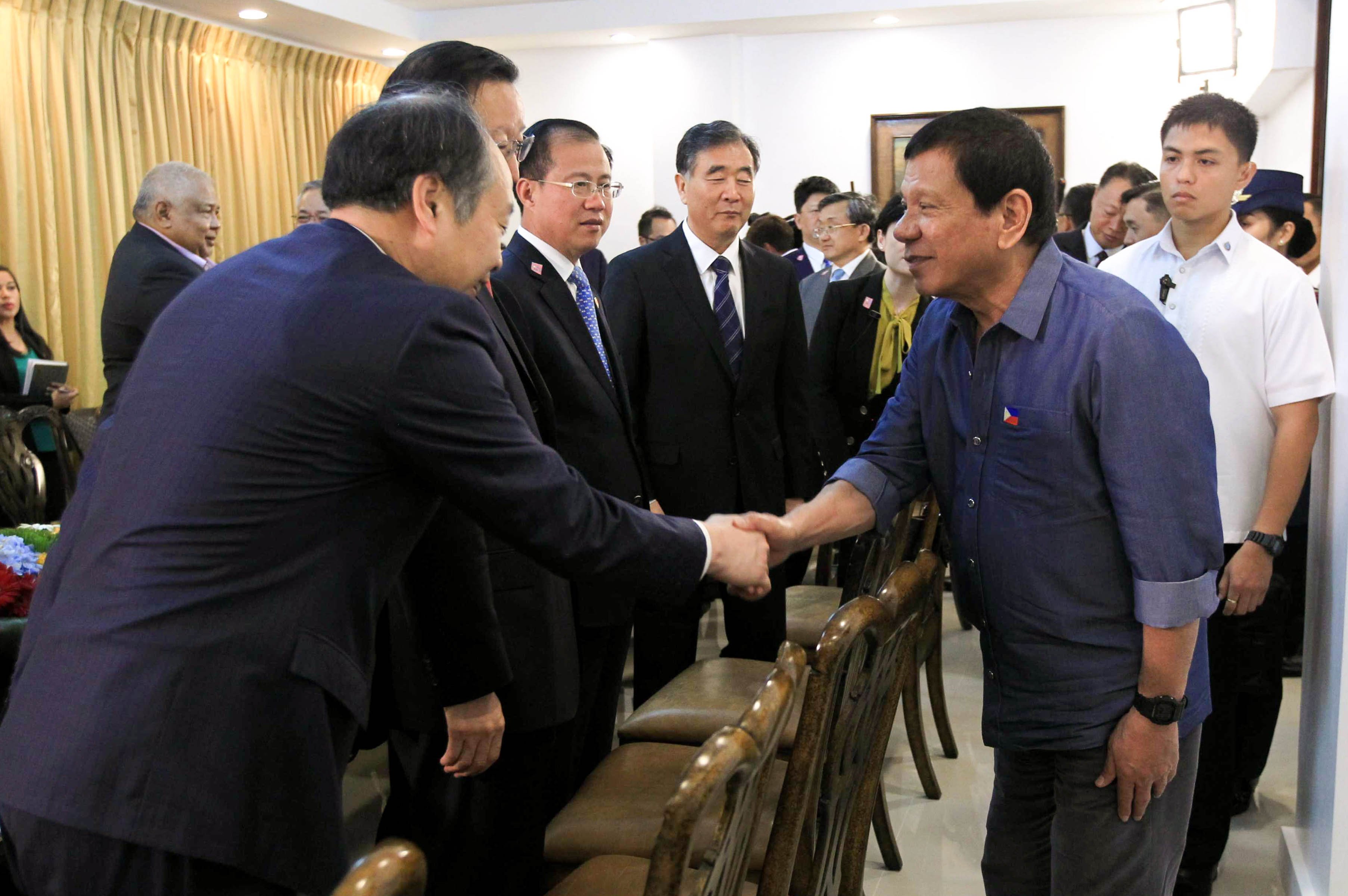 President Rodrigo Roa Duterte greets National Development and Reform Commission Vice Chairman Wang Xiaotao